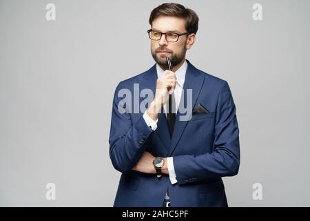 Studuo Schuss des Denkens Lösung Problem Geschäftsmann tragen Anzug halten Stift Stockfoto