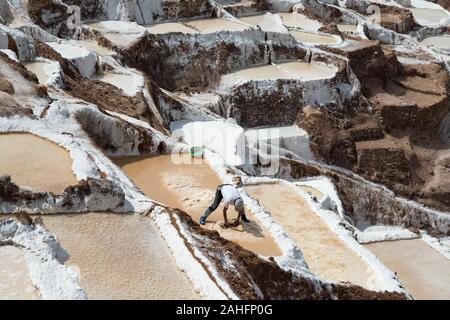 Arbeitnehmer manuell Extrahieren von Salz aus den Salinen Maras, Peru Stockfoto