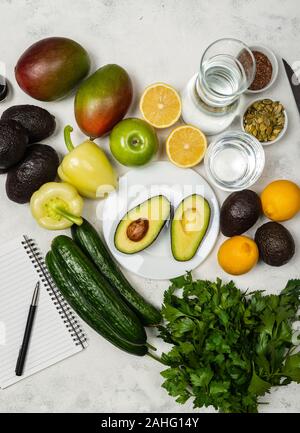 Zutaten für die Vorbereitung einer gesunden vegetarischen Salat. Rezept Notebook. Ansicht von oben. Stockfoto