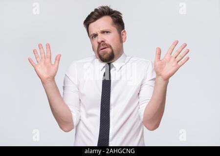 Zweifelnd junger Mann in Gläsern und gestikulierte mit Händen zu verleugnen, um in Ihrem Geschäft zu beteiligen. Stockfoto