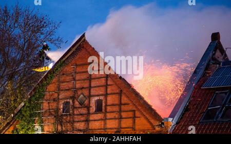 Barsinghausen, Deutschland. 30 Dez, 2019. Feuerwehrmänner ein großes Feuer löschen im Seminarhaus Ökostation Deister-Vorland in Großgoltern in der Region Hannover. Ein Feuer war im ehemaligen Bauernhaus am Morgen, das schnell auf den gesamten Dachstuhl ausgebreitet. Credit: Julian Stratenschulte/dpa/Alamy leben Nachrichten Stockfoto