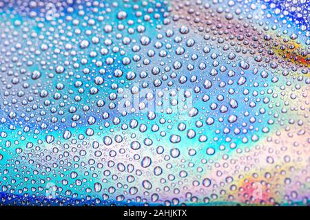 Wassertropfen auf Pastell holographische neon Hintergrund. Makroaufnahme. Stockfoto