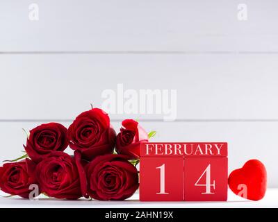 14. Februar, dem Valentinstag, Konzept. Februar 14 Buchstaben auf Holz- Kalender und Rosen auf Schreibtisch Stockfoto