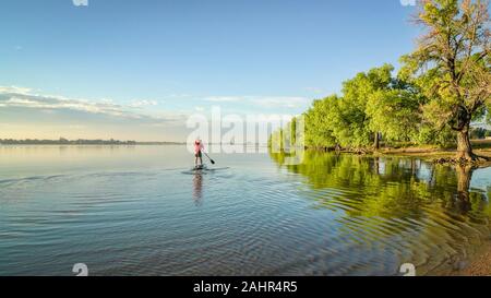 Stand up Paddleboard paddeln auf einem See im Sommer - Boyd Lake State Park im Norden von Colorado Stockfoto