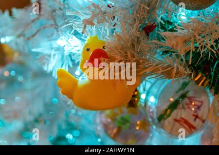 Eine niedliche gelbe Gummiente ist als alternative Christbaumschmuck verwendet. Stockfoto