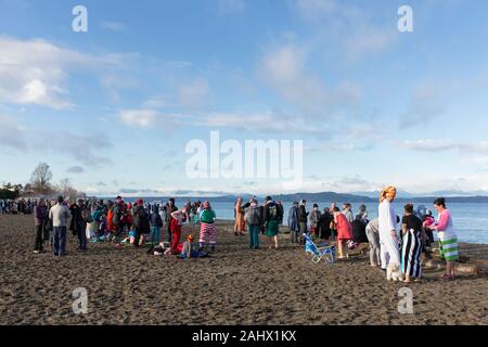 Hunderte für jährliche West Seattle Eisbären schwimmen Alki Beach Park versammelten sich am Mittwoch, den 1. Januar 2020. Milde Temperaturen inspirierte viele den Sprung zum ersten Mal zu nehmen. Stockfoto