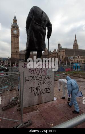 Polizei forensische Offiziere Spurensuche, die Verantwortlichen für die Graffiti und Beschädigungen an der Statue von Sir Winston Churchill in Parliament Square nach der Student Demonstration im Dezember 2010 zu finden. Stockfoto