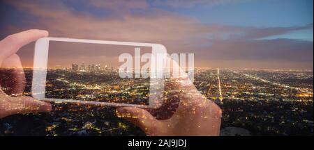 Doppelbelichtung Hände halten ein Handy und ein Bild von Stadt Los Angeles bei Nacht Stockfoto