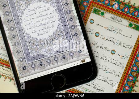 Digitale der Qur'an ein Smartphone und heiligen Quran Buch Stockfoto