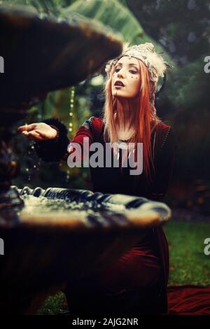 Schöne schamanische Frau mit Stirnband in der Natur. Stockfoto