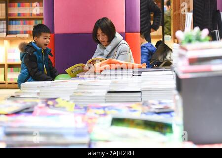 Hefei, Anhui Provinz Chinas. Am 4. Januar, 2020. Eine Frau und ein Junge lesen Sie ein Buch in einer Buchhandlung in Hefei, Osten Chinas Provinz Anhui, Jan. 4, 2020. Credit: Zhang Duan/Xinhua/Alamy leben Nachrichten Stockfoto