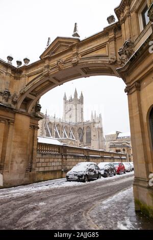 Die Abtei von Bath gesehen durch den Bogen auf die York Street an einem verschneiten Wintertag. Stockfoto