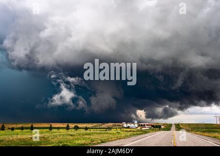 Stürmischer Himmel mit dramatischen, dunklen Wolken über einer Farm, während sich ein schweres Gewitter Anton, Colorado, nähert