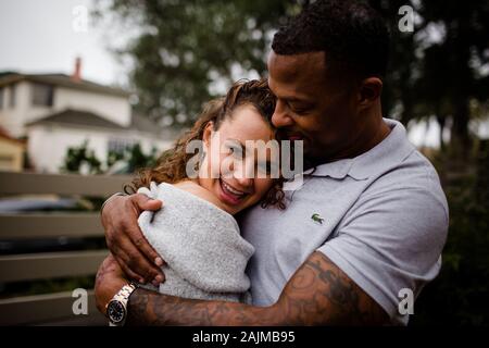 Biracial Paar Umarmt Späten Dreißiger Jahre Frau Lächelnd Stockfoto