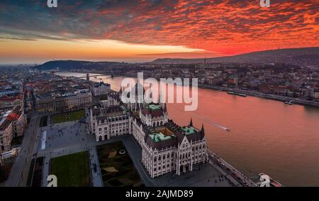 Budapest, Ungarn - Luftbild Panorama drone Ansicht des ungarischen Parlaments Gebäude auf einem Winter am Nachmittag mit einer erstaunlichen dramatische Bunte gold und Stockfoto