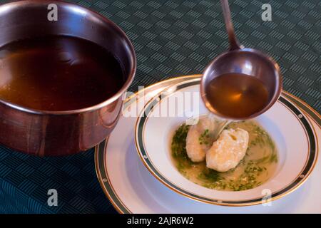 Das klare Rinderbrühe mit Butter Knödel, genannt Butternockerl in deutscher Sprache, die Suppe ist ein Teil der traditionellen österreichischen Küche. Stockfoto