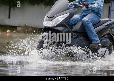 Splash von einem Motorrad wie geht es durch Hochwasser Stockfoto