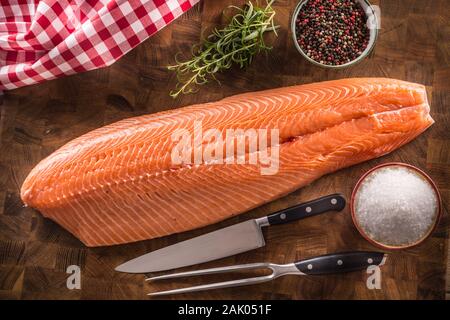 Ganze roher Lachs filet auf einer hölzernen Metzger board Stockfoto