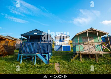 Mehrfarbige Urlaub hölzernen Umkleidekabinen am Strand mit Blick auf das Meer am Strand von tankerton Whitstable, Kent District England. Stockfoto