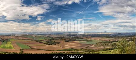 Ländliche Landschaft mit Dörfern, Feldern und Bergen im Hintergrund, blauer Himmel mit weißen Wolken, Blick vom Rip Berg, Ceske stredohori, Tschechische Rep Stockfoto