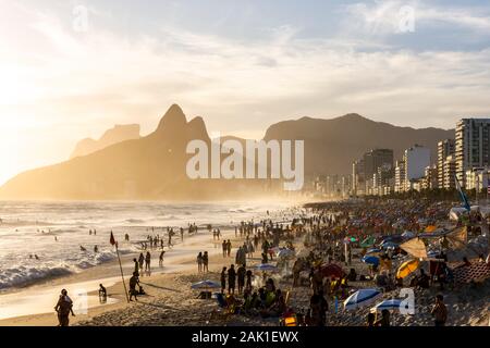 Wunderschöne Aussicht auf die Menschen genießen den Strand mit Big Mountain auf der Rückseite, Rio de Janeiro, Brasilien Stockfoto