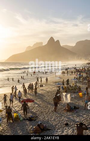 Wunderschöne Aussicht auf die Menschen genießen den Strand mit Big Mountain auf der Rückseite, Rio de Janeiro, Brasilien Stockfoto