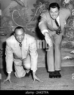 Ehemaligen olympischen Meister sprinter Jesse Owens und Schwimmer Johnny Weissmuller stellen gemeinsam im Jahre 1950 in Chicago. Stockfoto