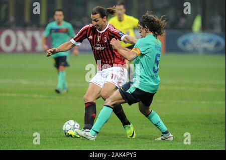 Mailand Italien ,23 NOVEMBER 2011, 'G.' Meazza San Siro Stadion, UEFA Champions League 2011/2012, AC Mailand - FC Barcelona: Zlatan Ibrahimovic und Carles Puyol in Aktion während des Spiels Stockfoto