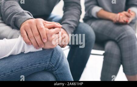 Beruhigend von Süchtigen. Mann raten verzweifelte Frau an der Gruppe Therapie Sitzung, Panorama, Nahaufnahme Stockfoto