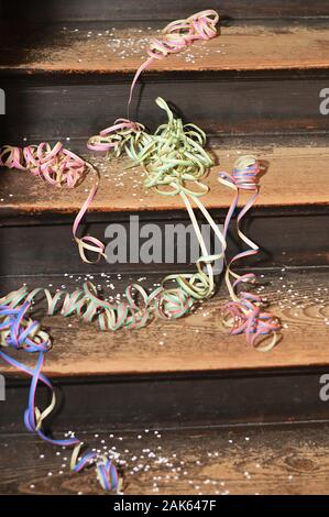 Nach einer Party - Reste von bunten Konfetti und Papier Farbbänder auf Holz Schritte Stockfoto