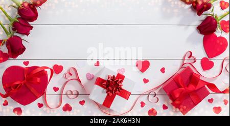 Geschenkboxen, ribbon Herzen und Rosen auf Weiß Tisch. Valentinstag geschenk Konzept Stockfoto