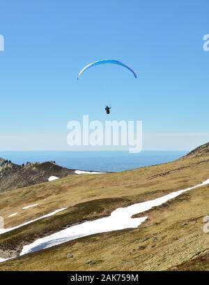 Gleitschirm fliegt auf einem vulkanischen Berge. Dies ist extrem Sport Stockfoto