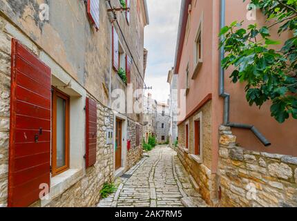 Eine gepflasterte Gasse zwischen alten Gebäuden in der historischen Altstadt in Ballen, einer kleinen Stadt auf dem Mont Perin in der Gespanschaft Istrien, Kroatien Stockfoto