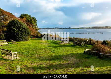 Farbiges Landschaftsfoto mit Blick auf den Hafen, mit Pier und Sandbanks Millionärsreihe in der Ferne, aufgenommen auf Dem Abendhügel Poole Stockfoto