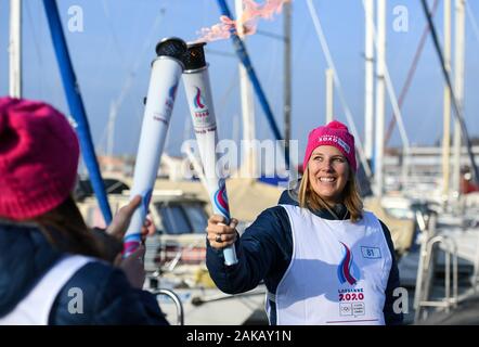 (200108) -- LAUSANNE, Januar 8, 2020 (Xinhua) - der Fackelträger Louise Thilo (R) übergibt die Fackel an Celine van Bis während des Fackellaufs für die 3 Jugend Olympischen Winterspiele in Lausanne, Schweiz, Jan. 8, 2020. (Xinhua / Lu Yang) Stockfoto