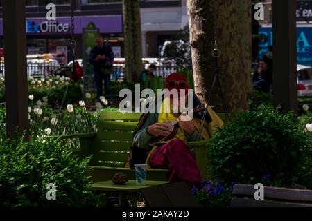New York, NY, USA - 14. Mai 2015. Foto eines Mannes, Sitzen, Spielen eine Ukelele im Bryant Park, New York City. Stockfoto
