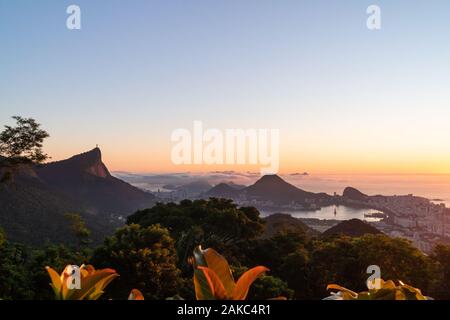 Sonnenaufgang über der Stadt Rio de Janeiro, Zuckerhut und die Christusstatue Statue von Vista Chinesa. Stockfoto