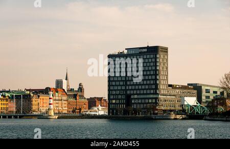 Malmö, Schweden - 6. April 2019: Das Studio ist ein kombiniertes Hotel- und Bürogebäude im Innenhafenbereich, das hier bei Sonnenuntergang im Frühling von der Küste aus zu sehen ist Stockfoto