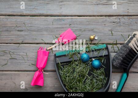 Reinigung bis nach Weihnachten. Fegen herauf Tannennadeln und kaputte Dekorationen Stockfoto