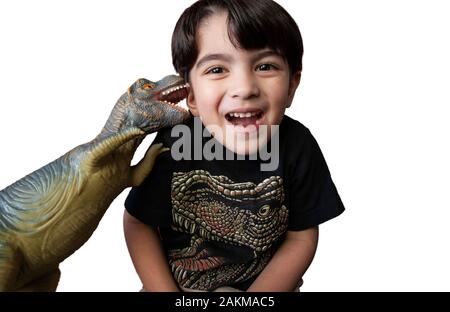 Porträt eines jungen Latino Junge spielt mit seinem Plastik Spielzeug Dinosaurier Stockfoto