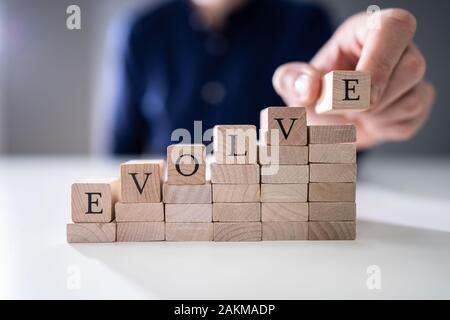 Nahaufnahme der Hand letzte Alphabet der Person des Wortes Entwickeln auf hölzernen Block Stockfoto