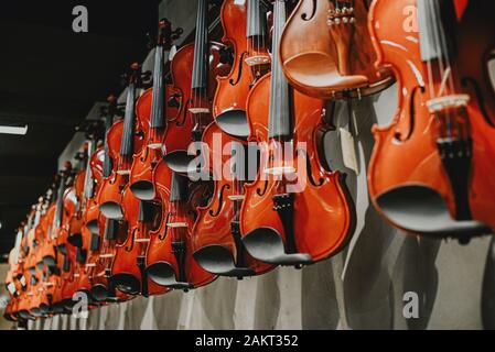 Aussicht auf eine hölzerne braune Geige im Fenster von Ein Musikgeschäft Stockfoto