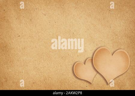 Braun Handwerk Papier Hintergrund mit zwei Herzen zum Valentinstag Stockfoto