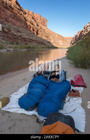 Paar Schlafen unter den Sternen" am Strand entlang dem San Juan River, Utah. Stockfoto