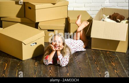 Neue Wohnung, Kauf eines neuen Wohnhauses. Pappkartons - Umzug in neues Haus. Glücklicher Kinderkarton. Glückliches kleines Mädchen mit Spielzeug. Suite Dreams. Stockfoto