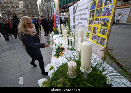 Köln, Deutschland. 11 Jan, 2020. Eine Frau legt eine Blume für die Opfer der Passagierflugzeug abgeschossen durch das iranische Militär bei einer Kundgebung des deutsch-iranischen Gesellschaft gegen die Verhaftung von Oppositionellen im Iran. Quelle: Henning Kaiser/dpa/Alamy leben Nachrichten Stockfoto