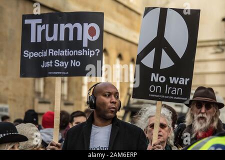 London, Großbritannien. 11. Januar, 2020. Ein Mann hält zwei Plakate. "Trump, besondere Beziehung? Sagen Sie einfach Nein' und kein Krieg gegen den Iran". Nach der Ermordung von Qasim Soleimani in Bagdad von den USA und der zunehmenden Spannungen im Nahen Osten, Demonstranten marschierten durch die Londoner "kein Krieg gegen den Iran "Nachfrage", Truppen kein Krieg gegen den Irak und aus dem Irak". Sie sammelten in Trafalgar Square reden von einer Reihe von Menschen, darunter auch Jeremy Crobyn zu hören. Die Veranstaltung wurde gemeinsam von der Stoppt den Krieg Koalition und der Kampagne für Nukleare Abrüstung und ähnliche Veranstaltungen statt um Großbritannien organisiert worden. David Stockfoto