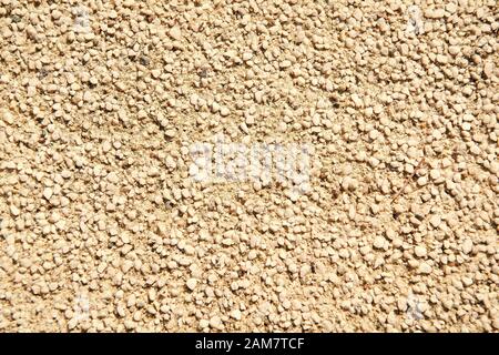 Rau und ungleichmäßig. Sand und Stein Oberfläche. Sandstrand Stein Textur. Kies Kiesel oder Steinen. Stein Boden. Abstrakte Stein Hintergrund für Tapeten. Stockfoto