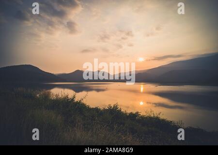 Berg, Himmel und Fluss in ruhiger und kühler Atmosphäre. Ähnliches Farbschema .Blick auf blaue Berge mit Spiegelung im See . Querformat mit blauer mou Stockfoto