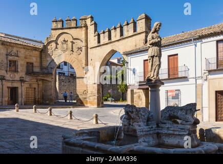 Fuente de los Leones, oder Brunnen des Löwen, in der Plaza del Populo, Baeza, Provinz Jaen, Andalusien, Spanien. Die ornamentale City Gate in der Rückseite Stockfoto